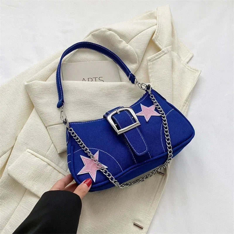Tess – compacte schouder tas met star patroon en korte hengsels