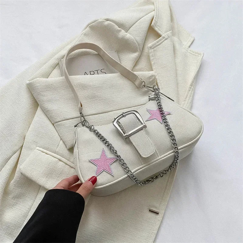 Tess – compacte schouder tas met star patroon en korte hengsels