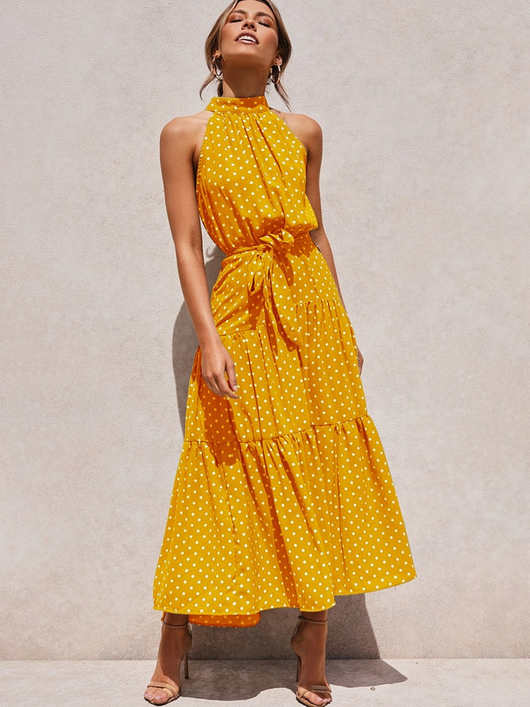 Lola – Zwart-witte halter midi-jurk met polkadots en flatterende tailleceintuur