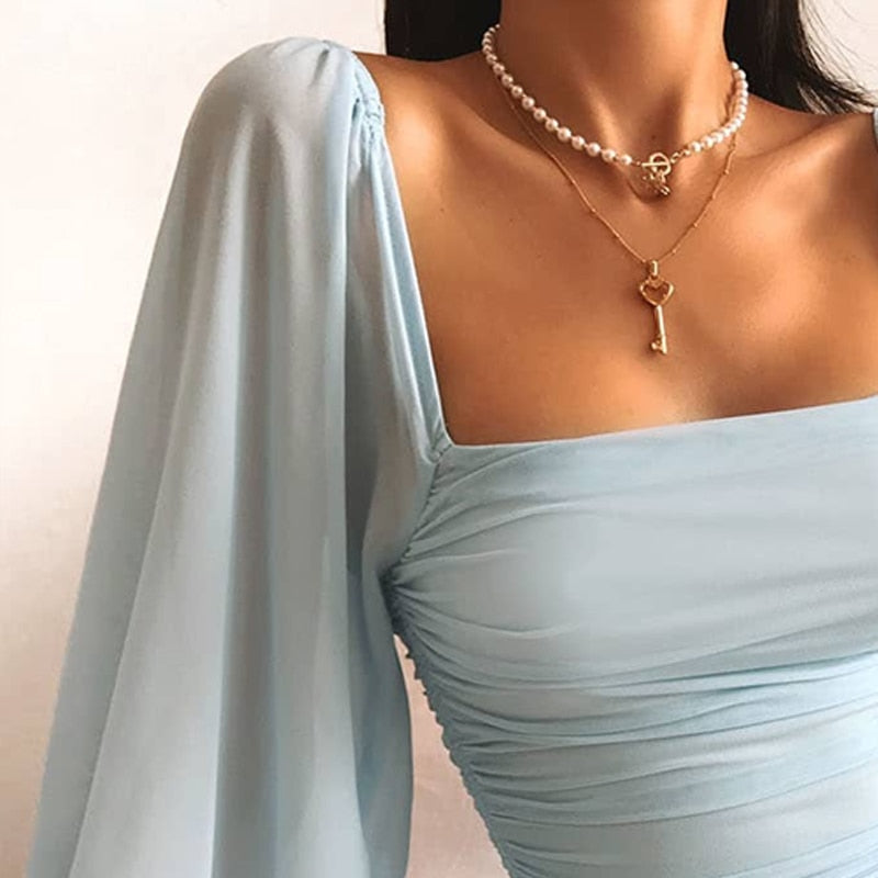 Giulia – Bodycon mini-jurk met rechte hals transparante pofmouwen en trekkoorden